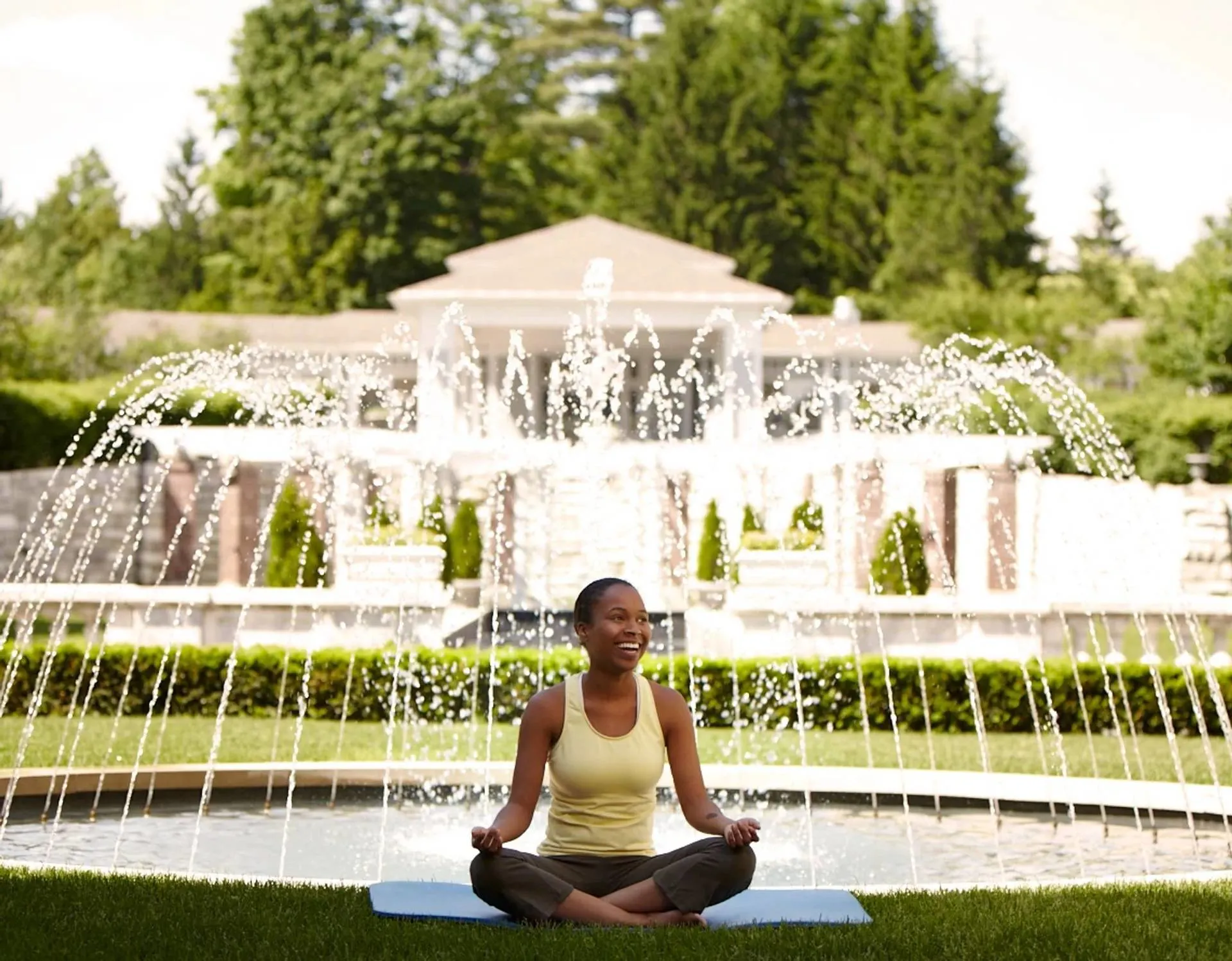 canyon ranch lenox wellness retreat in massachusetts woman in yoga post in front of fountain